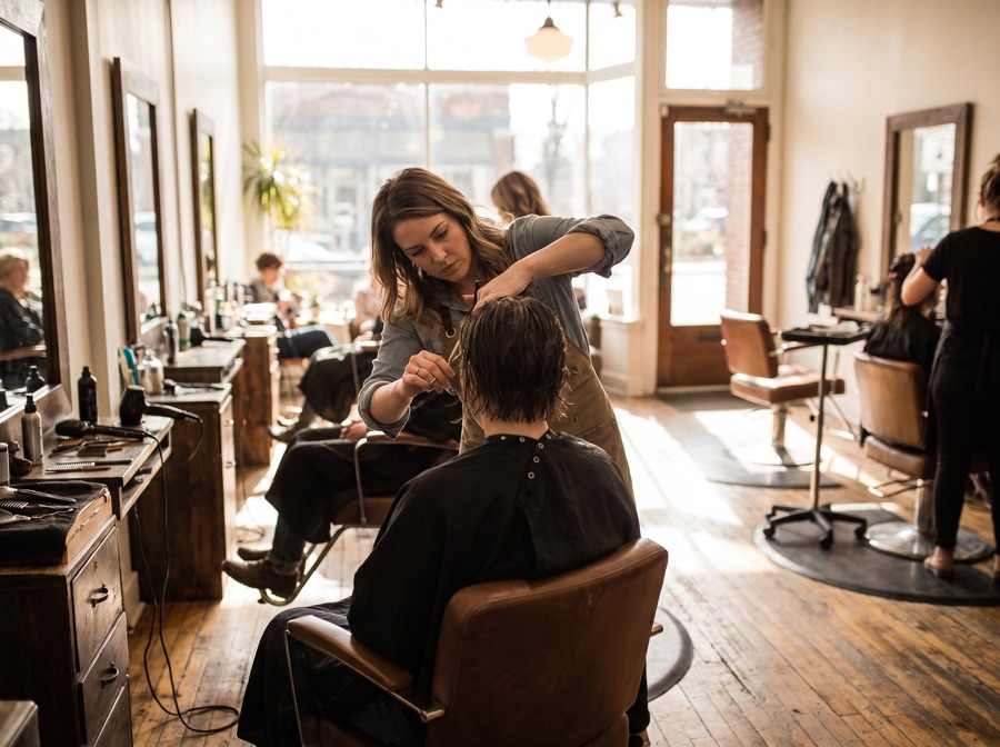 A stylist cutting hair in a salon